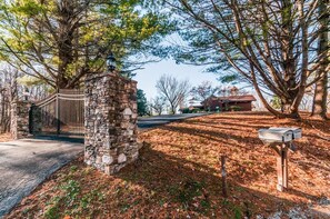 residence with a single-story home and mature trees surrounding the property.