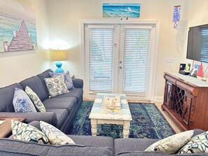A living room with a sofa, a coffee table, and a television. - Casa Cay West Beautiful Tropical  3 bedrooms 2 KING suites - 2 miles to beach (Key West)