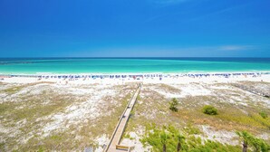A beach with a wooden boardwalk leading to the shore, white sand, and a clear blue sky. - 7th Floor Two Bedroom ~ Phoenix East (Orange Beach)