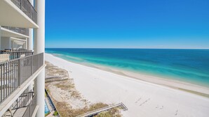 A beachfront hotel with balconies overlooking a sandy beach and turquoise waters. - The Oasis at Orange Beach, formerly known as Phoenix West II, Unit 1503 (Orange Beach)