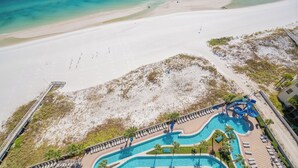 A resort with a large pool area, a beach, and a boardwalk. - The Oasis at Orange Beach, formerly known as Phoenix West II, Unit 1503 (Orange Beach)