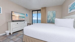 A hotel room with a large bed, a television, a dresser, and artwork on the walls. - 6th FLOOR! XTRA BATH! 3 BR 3 BA ~ Phoenix X (Orange Beach)