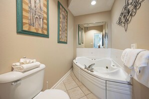 A bathroom with a toilet, a bathtub, and a sink. There are towels on the toilet and the bathtub. - 2 BR @ Phoenix VII - *Reserved Parking* (Orange Beach)
