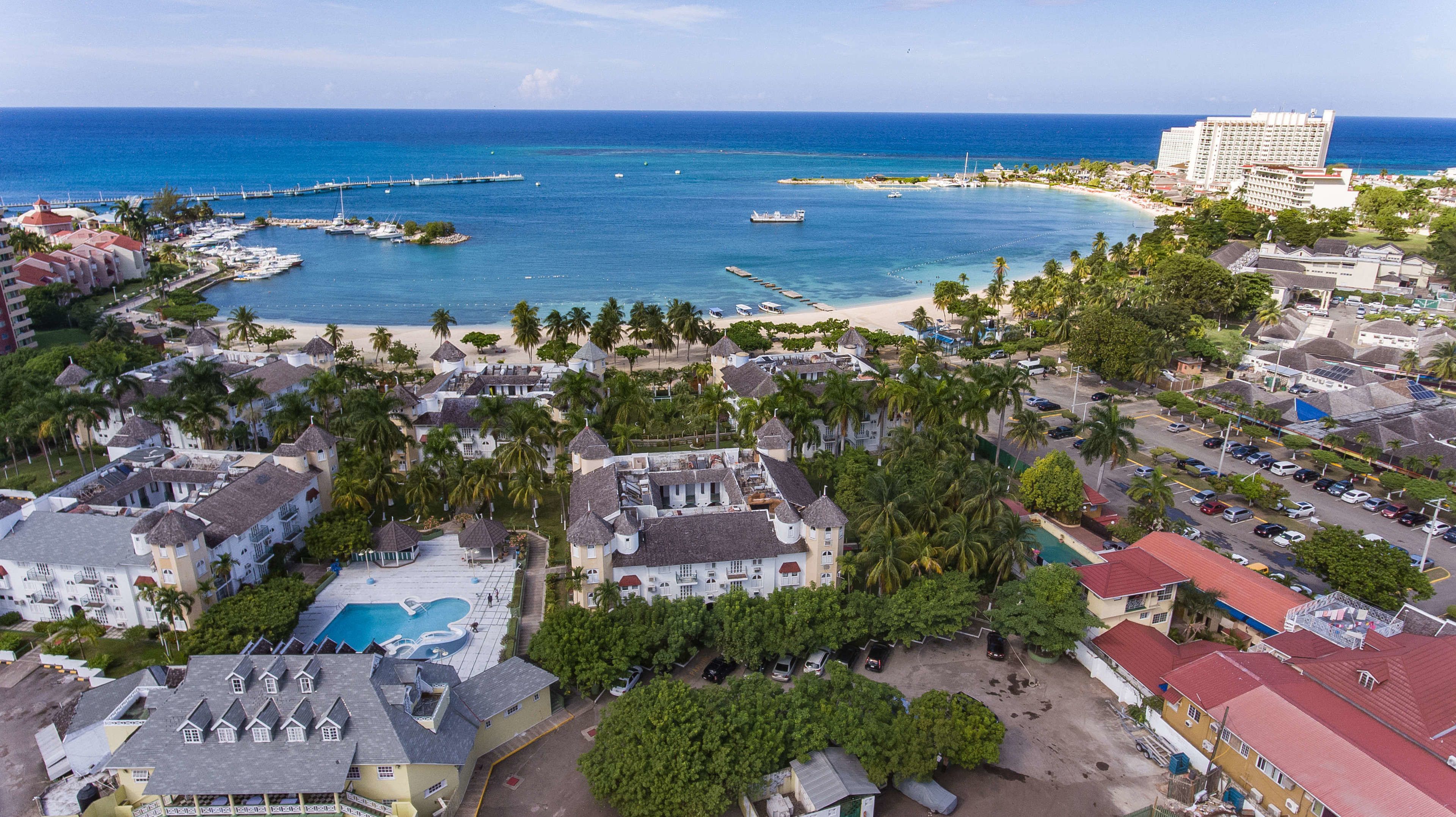 A coastal resort with a marina, beachfront, and a large hotel.