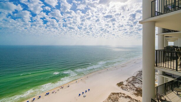 A beach view from a balcony with a clear sky and ocean. - The Oasis, Unit 2209 — Luxury 3BR/4BA Gulf-Front Condo with Resort Amenities (Orange Beach)