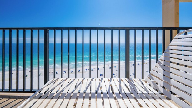 Un balcón con vista a la playa y al océano.