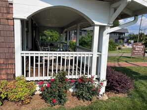 A covered porch with outdoor seating and a sign for Haywood House. - Haywood House: West Asheville's Newly Restored And Most Walkable Rental! (Asheville)