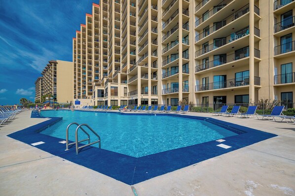 Relax by the sparkling pool with lounge chairs and easy access to beachfront fun at this inviting rental property