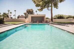 A swimming pool with a covered area, steps leading into the pool, and surrounding greenery. - Architect-Designed Retreat with a BBQ Patio and Pool (Mesa)