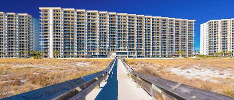 Walk along the boardwalk to your beachfront retreat at Phoenix VII, where stunning views and relaxation await just steps away
