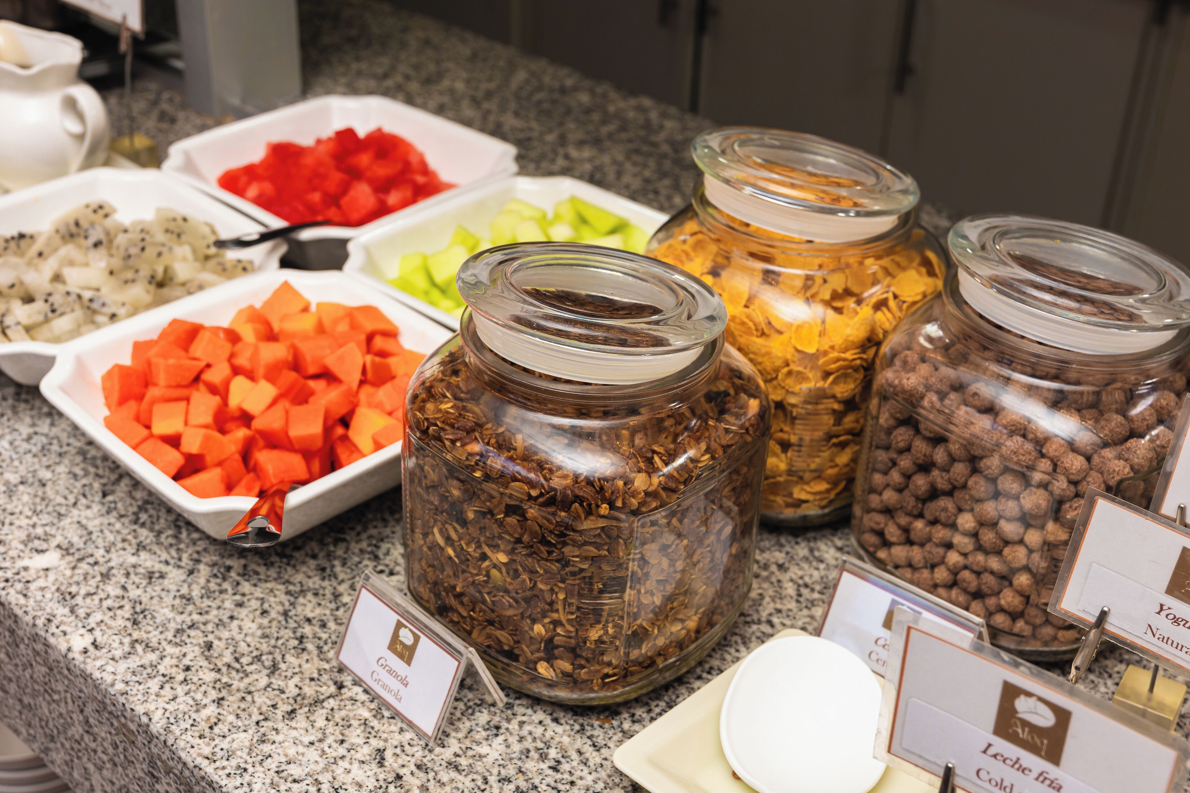 A food display with various items like diced vegetables and grains.