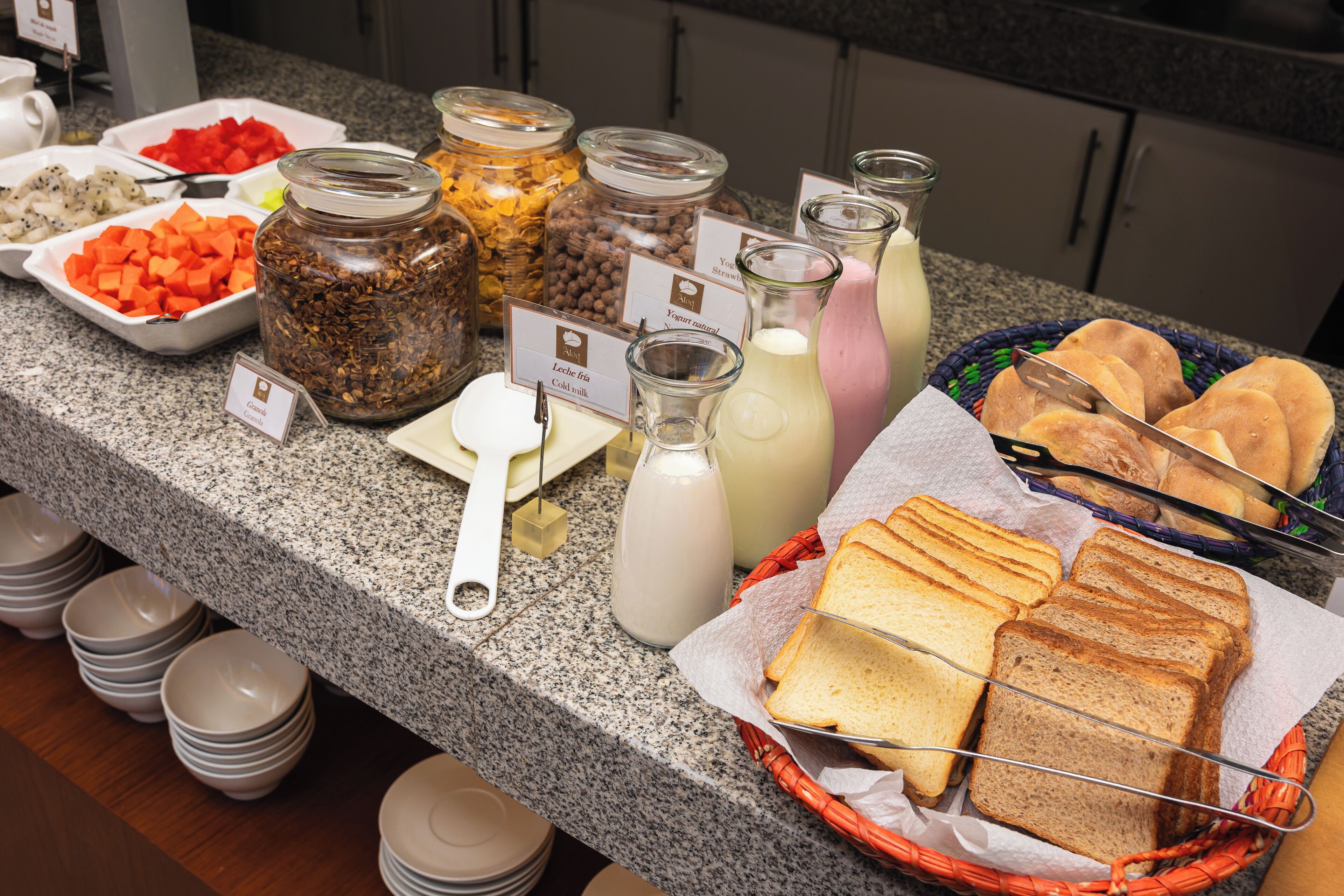 A buffet with various food items and beverages.