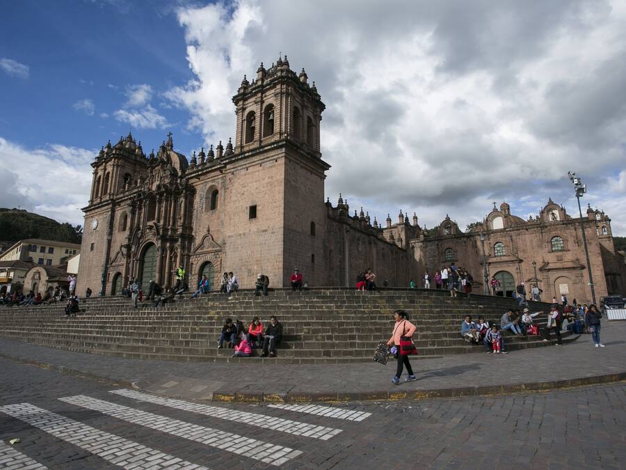 A historic church with a prominent bell tower and steps leading up to it.