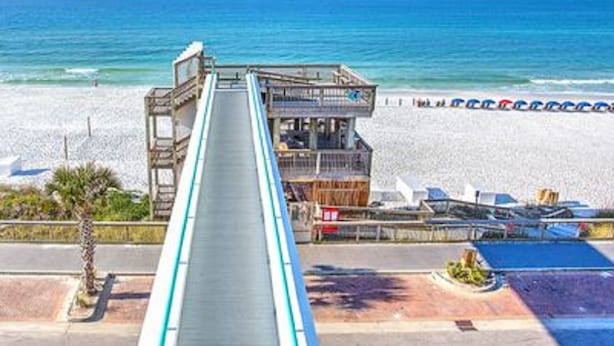 A beachside building with a long, narrow structure leading to a deck area overlooking the ocean. -  So Cozy & Serene Perfect Getaway Gulf Front Studio  
Private  Balcony Bch Srv  (Miramar Beach)