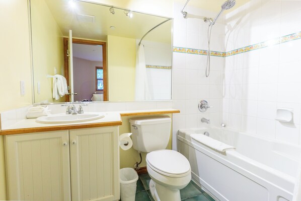 A bathroom with a sink, toilet, and bathtub. - Aspens #252 Prime Ski-in Ski-out Location! Pool, Hot tubs, BBQ, sleeps 6 (Whistler)
