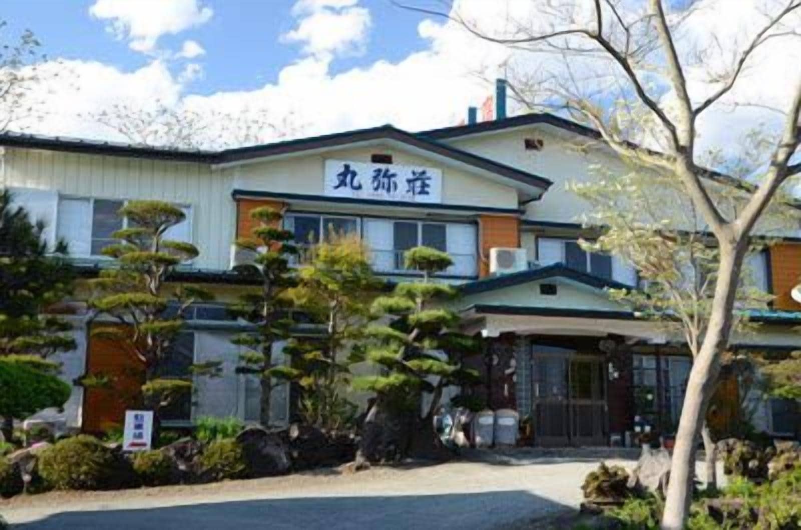A building with a sign that reads "九辻荘".