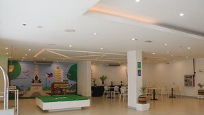 A spacious indoor area with a play area, seating, and a wall with educational murals. - Go Hotels Ermita (Manila)