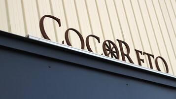 A building with a corrugated metal exterior and the word "Cocorreto" in large letters.