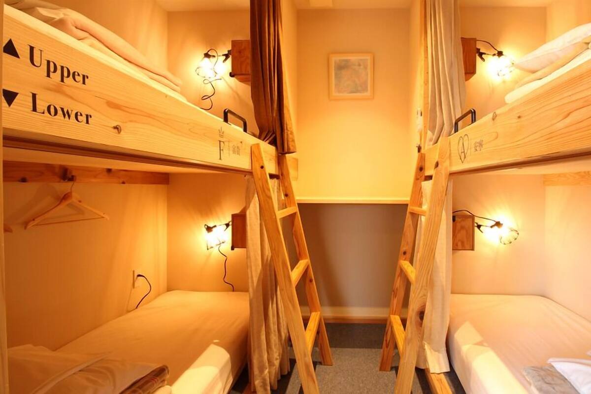 A room with bunk beds labeled 'Upper' and 'Lower' with a ladder in the center.
