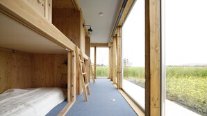 A room with a bunk bed, a ladder, and a window with a view of a field. - COCORETO THE GUEST HOUSE - Hostel (Matsue)