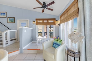 Relax in this inviting living area with a sofa and a view of the outside through the window.