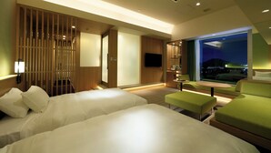 A hotel room with two beds, a seating area, a TV, and a city view. - Candeo Hotels Nara Kashihara (Kashihara)