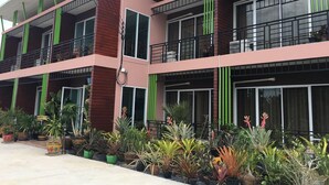 A multi-story building with balconies and large windows. - Baan Suan Punpaka Resort (La-ngu)