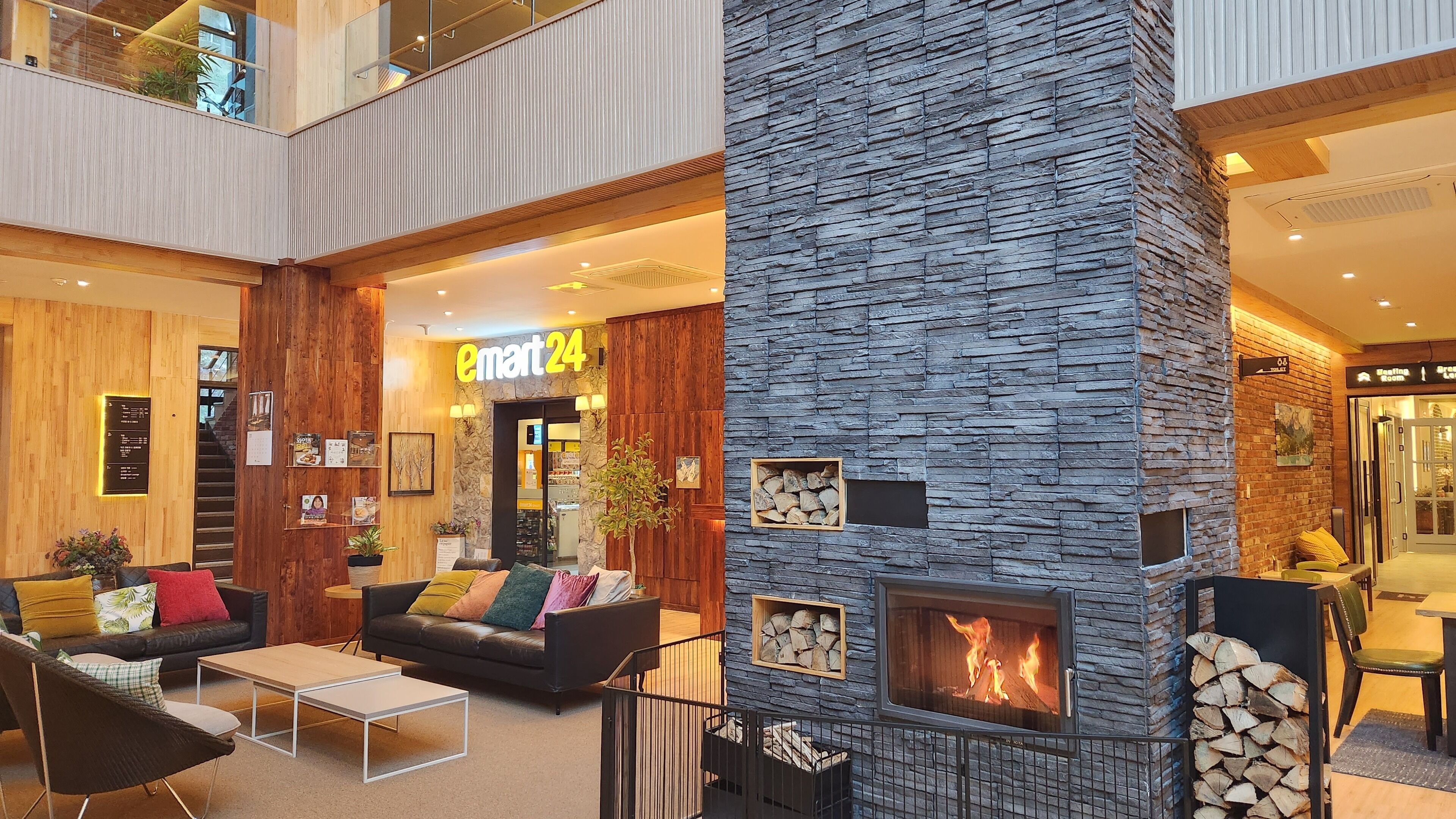 A modern indoor space with a stone fireplace, a sofa, and a coffee table.