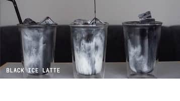 Three glasses of black ice latte with ice cubes, one being filled with a dark liquid from a metal jigger.