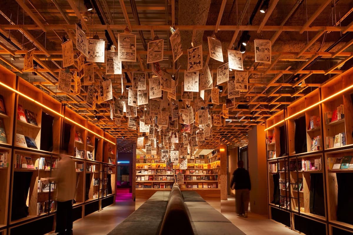 A library with bookshelves on both sides and a central walkway.