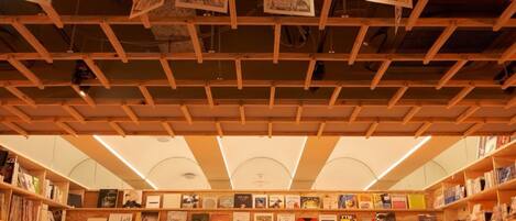 A bookstore with bookshelves and hanging posters.