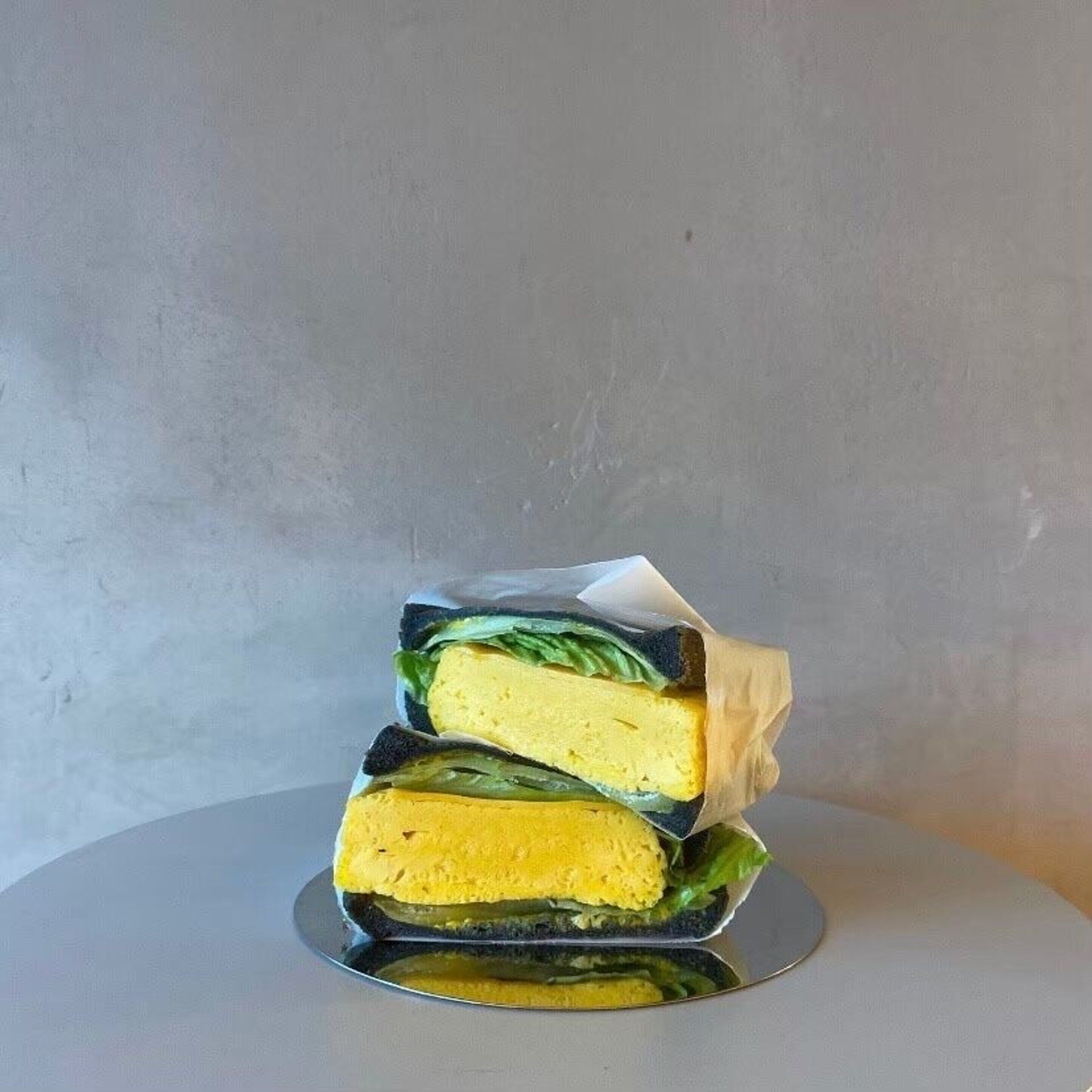 A sandwich on a reflective surface.