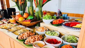 A buffet table with various dishes including salads, vegetables, and beans. - Phurua Inn (Phu Ruea)