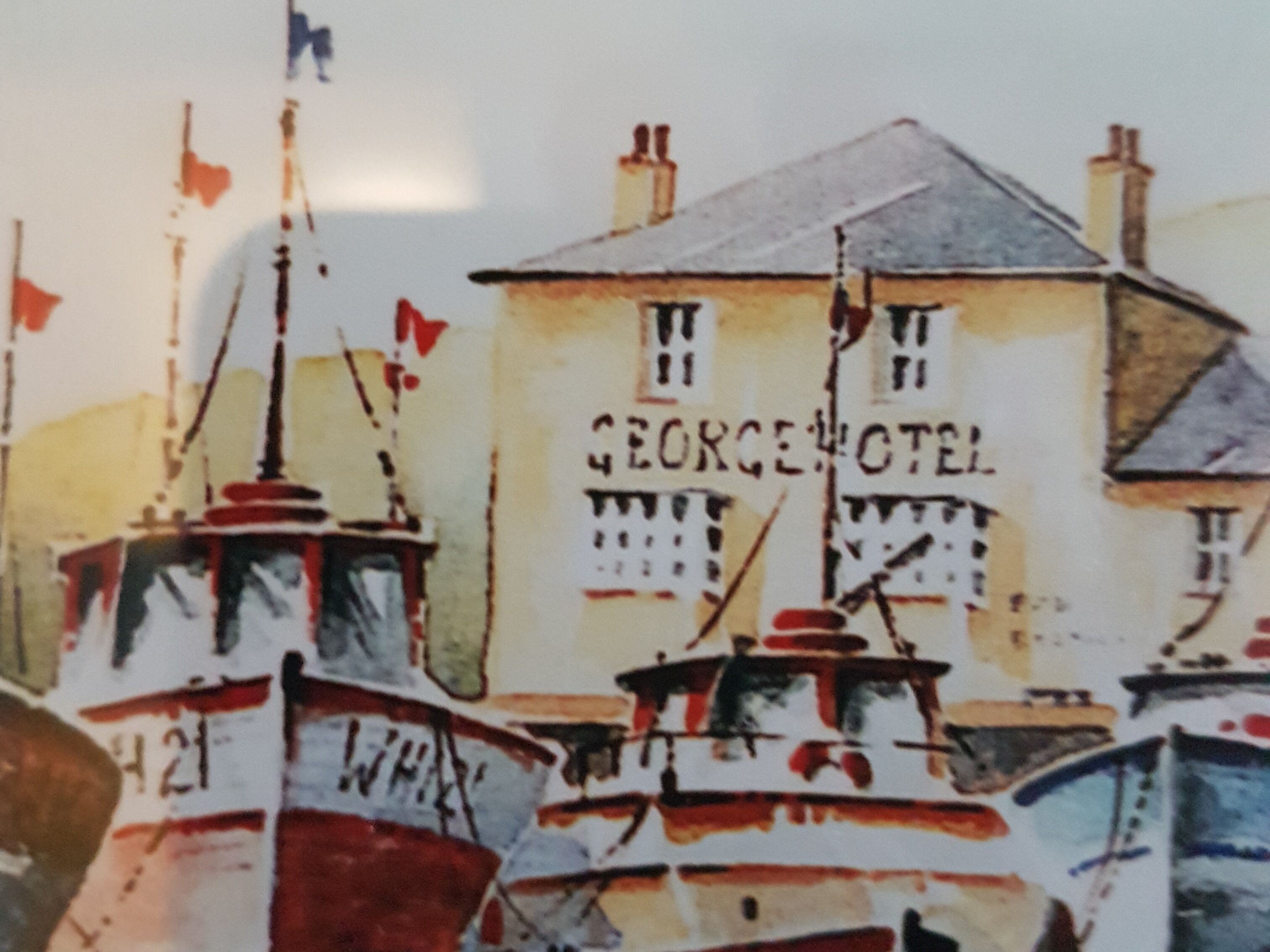 Een gebouw met de naam ‘GEORGE HOTEL’ op de gevel.