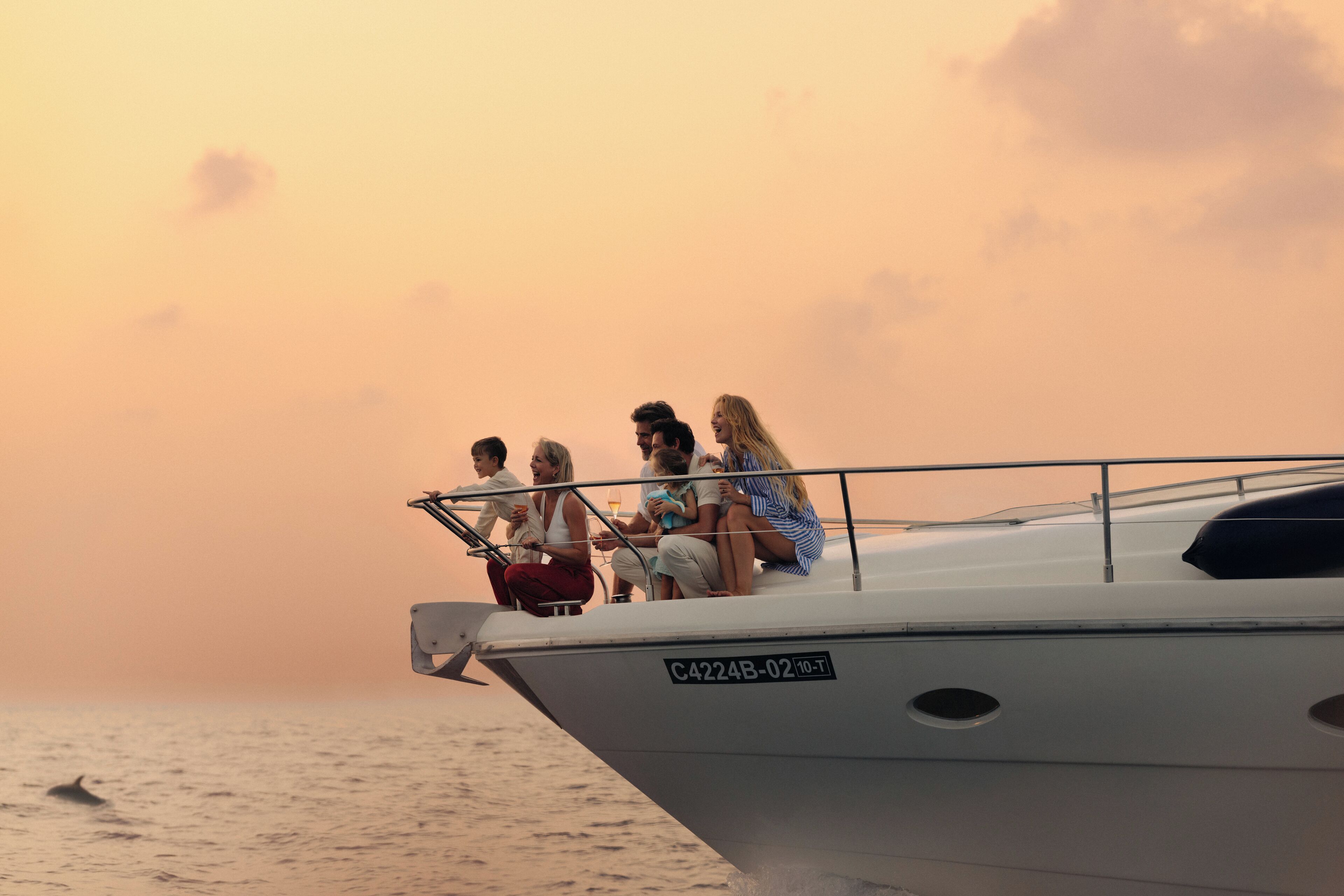 A group of people on a boat with a registration number C4224B-02-10-T.