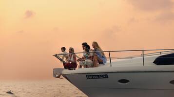 A group of people on a boat with a registration number C4224B-02-10-T.