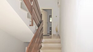 A staircase with wooden railings leading to a doorway.