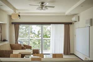 SCALLOP (Beach Apartment) Room C | Living area | Flat-screen TV - T&T Vacation Rentals (Onna)
