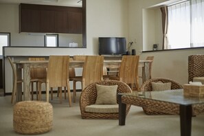 SCALLOP (Beach Apartment) Room C | Living area | Flat-screen TV - T&T Vacation Rentals (Onna)