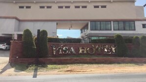 A modern building with a sign that reads "VISA HOTEL" in front of it. - Visa Hotel (Bangkok)