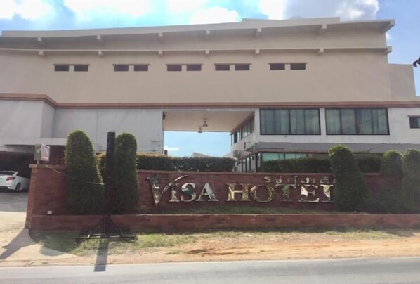 A modern building with a sign that reads "VISA HOTEL" in front of it.
