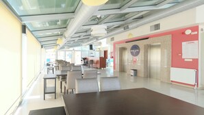 A modern hotel lobby with a reception desk, seating area, and elevator. - Siyav Hotel (Ankara)