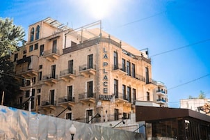 A multi-story building with the sign "LAP LACE HOTEL" on its facade.