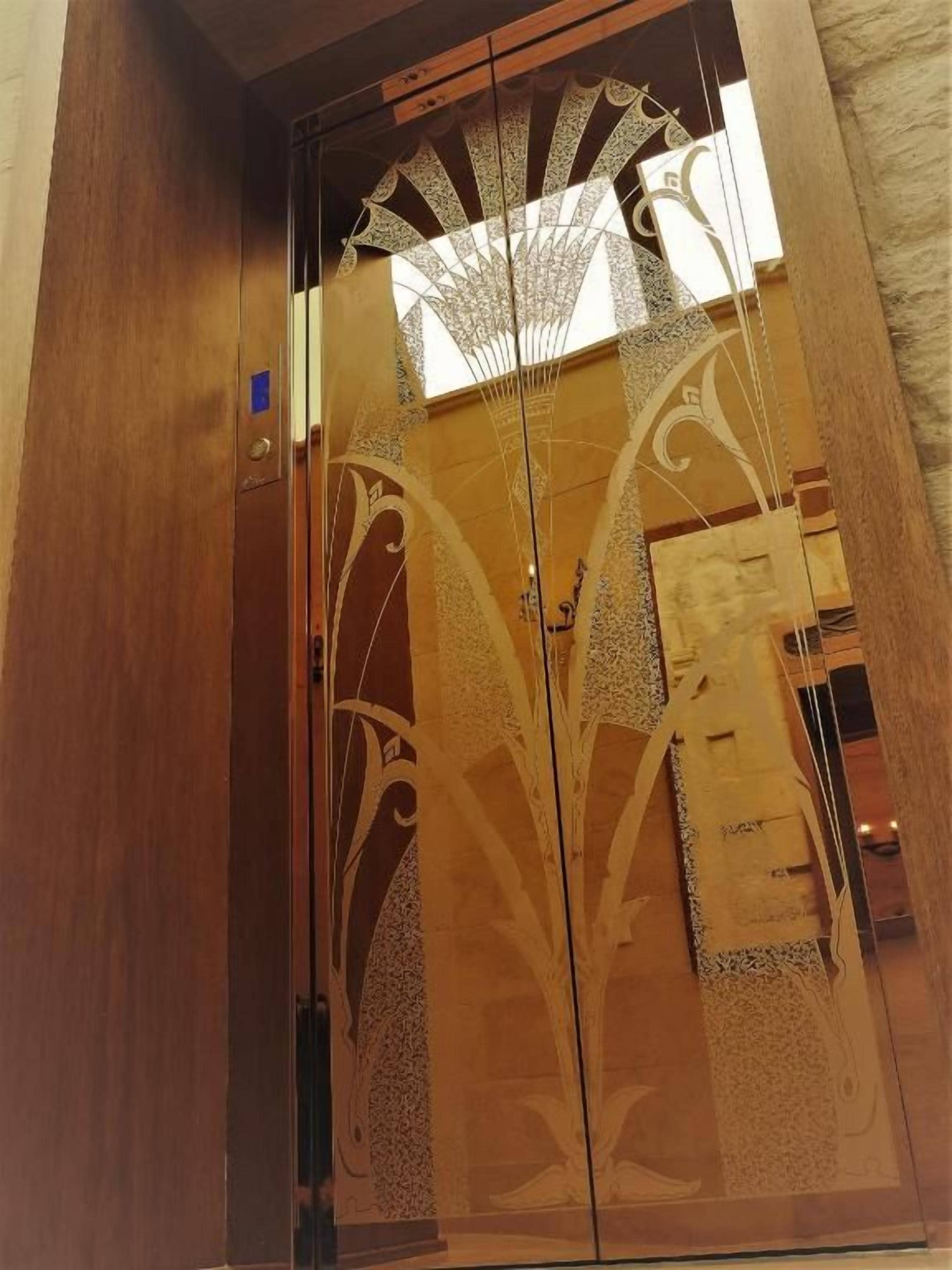 A double door with intricate designs and a reflective surface.