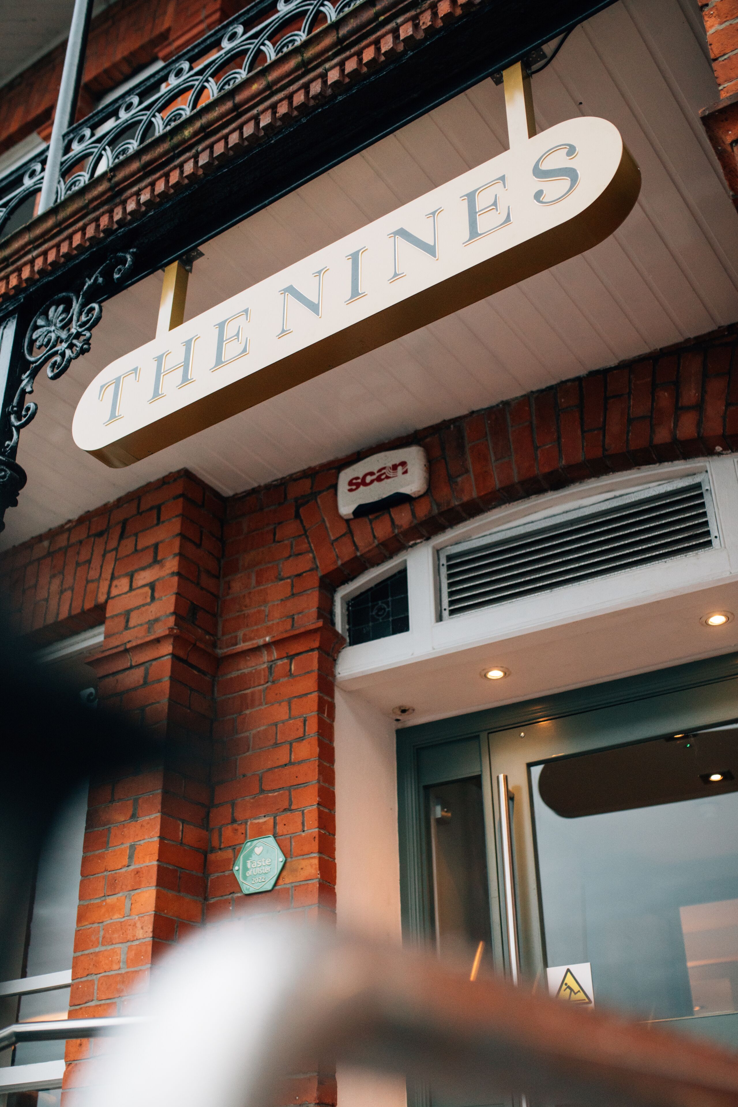 A building with a sign that reads "THE NINES".