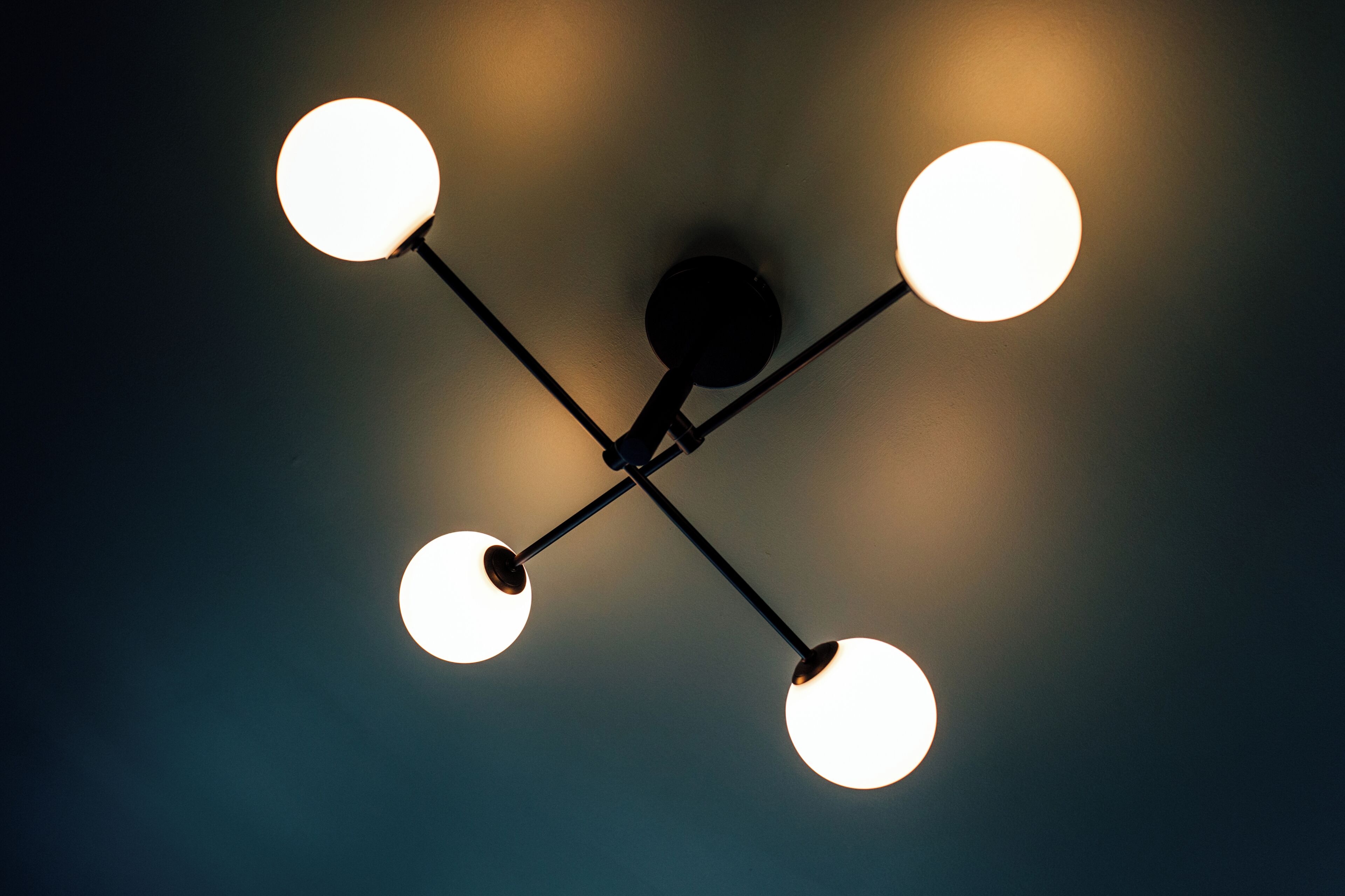 A ceiling with four spherical light fixtures.
