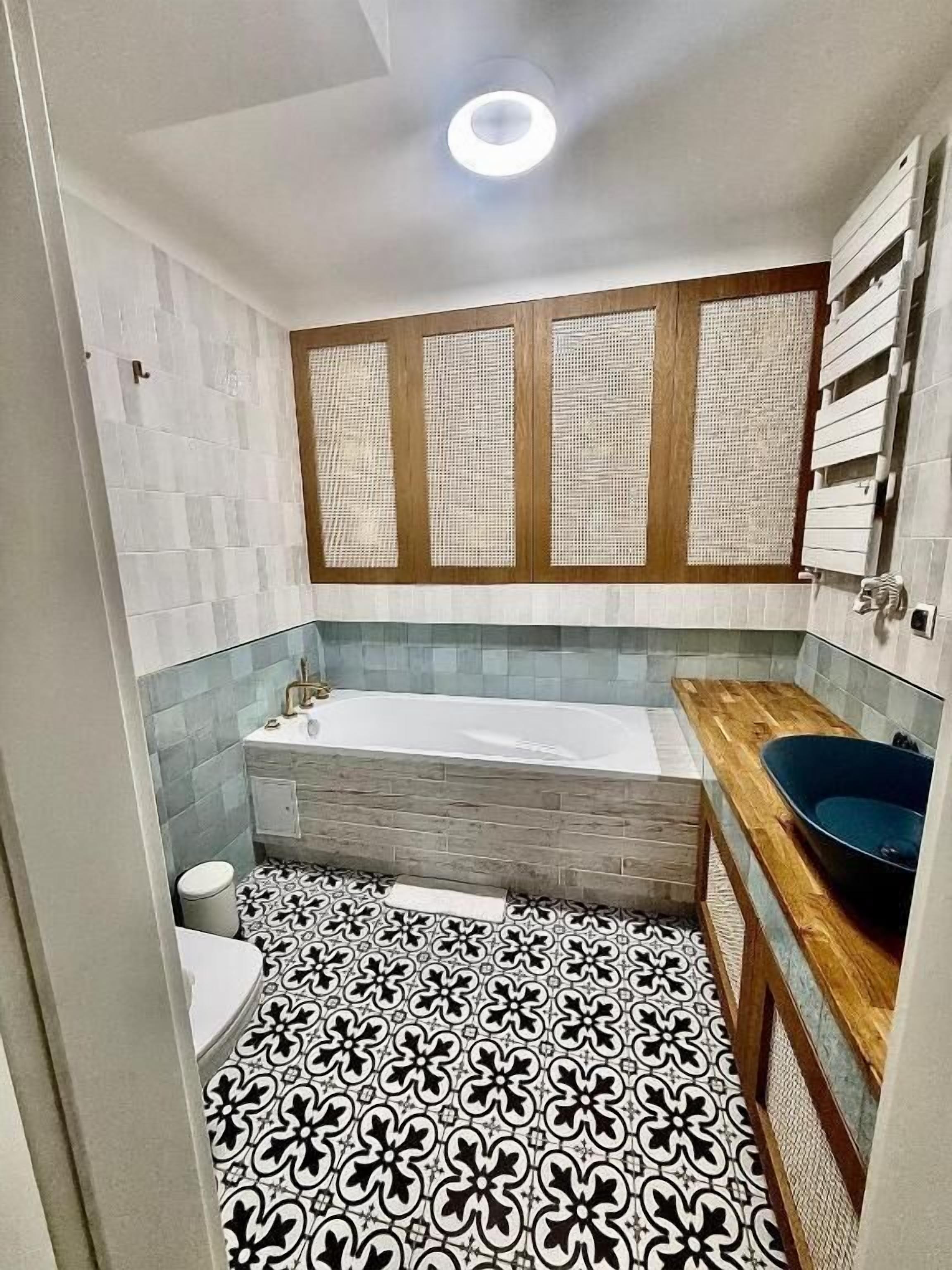 A small bathroom with a bathtub, a sink, and a toilet.