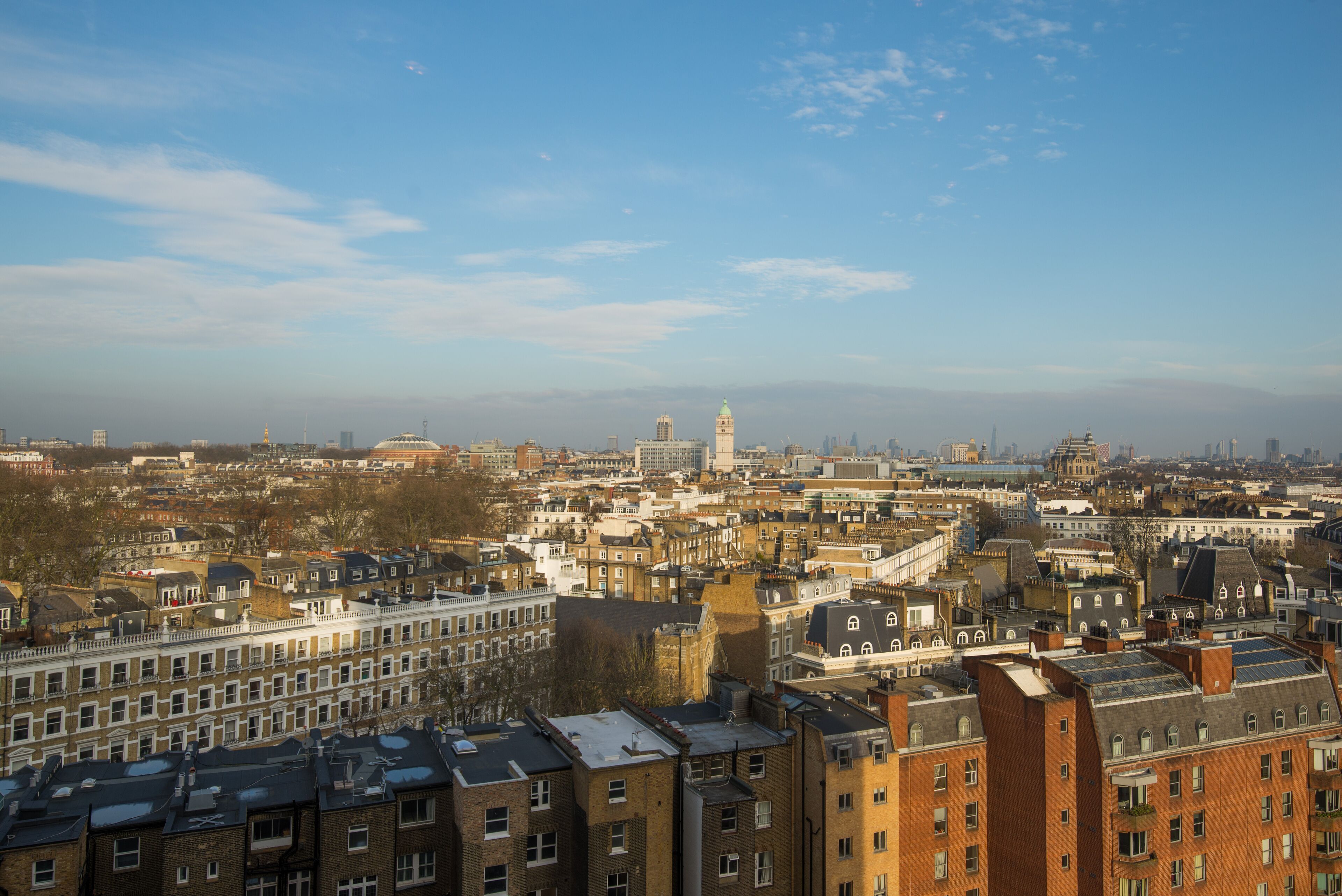 A cityscape with a mix of historic and modern buildings, including a prominent tower and a dome.