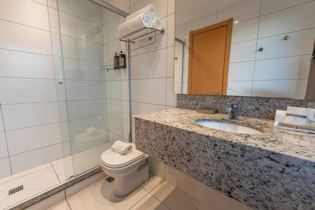 deluxe single room (stilo) | bathroom | shower, hair dryer, towels, soap