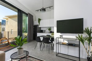 One Bedroom Apartment with Balcony - House No. 52 | Living area | Flat-screen TV
